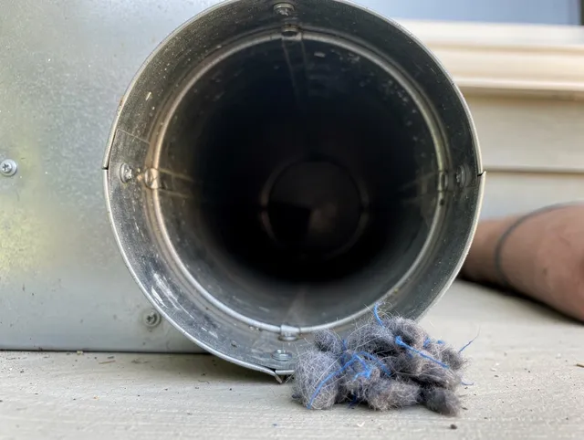 Old Saybrook Dryer Vent Cleaning technician using specialized equipment to clear severe dryer vent blockage in Old Saybrook